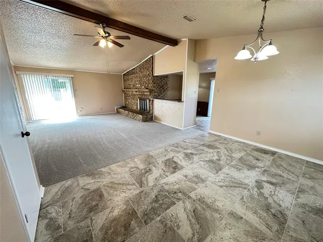 a view of a livingroom with a ceiling fan and window