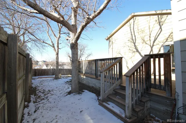 a view of backyard with a deck and a backyard