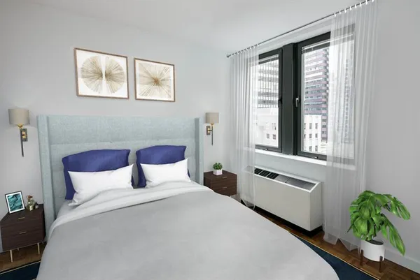 a bedroom with a bed and a large window