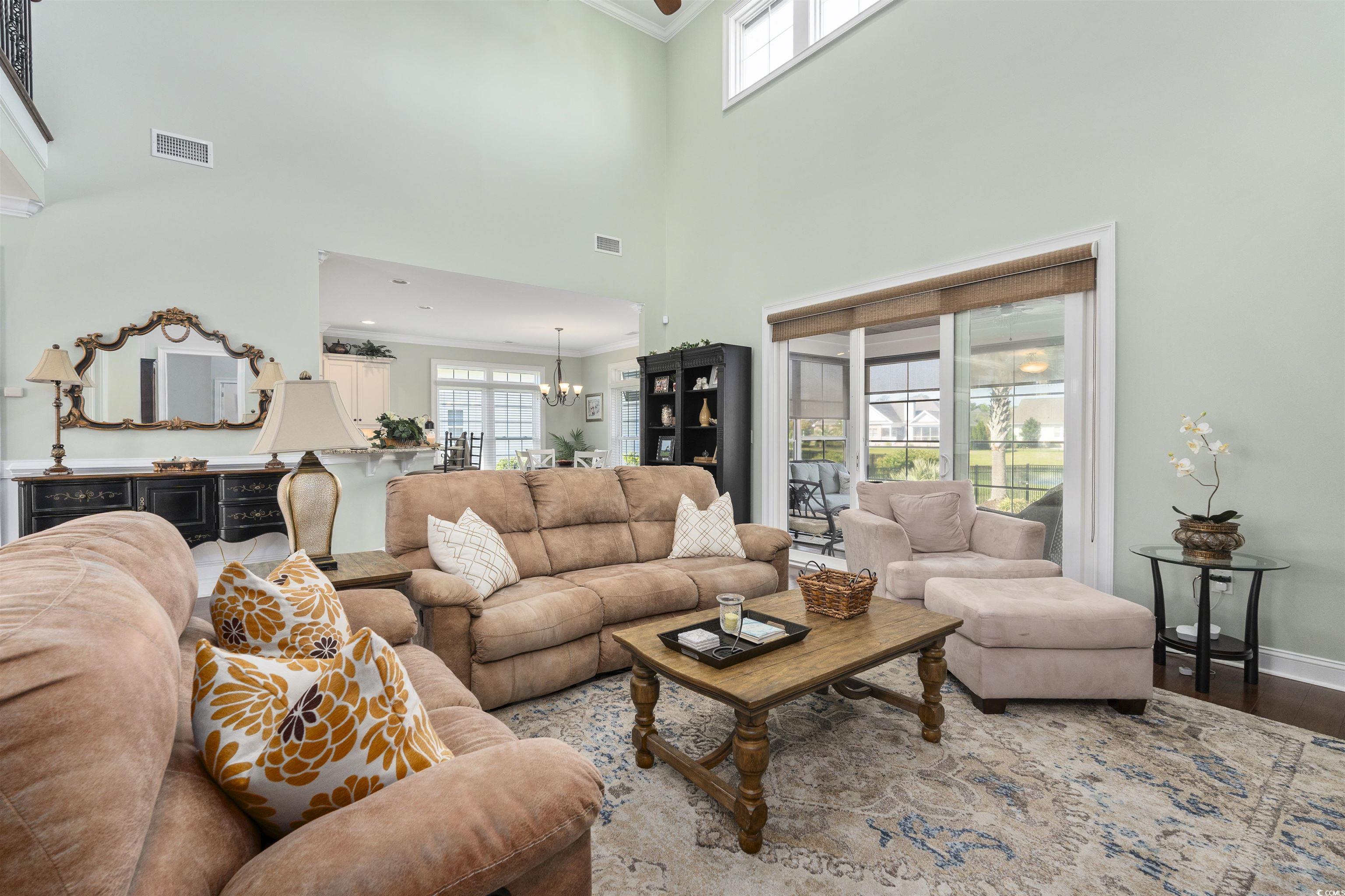 63 Grey Moss Road Murrells Inlet, SC 29576 - Photo 8 of 35 Living room with ornamental molding, a chandelier,