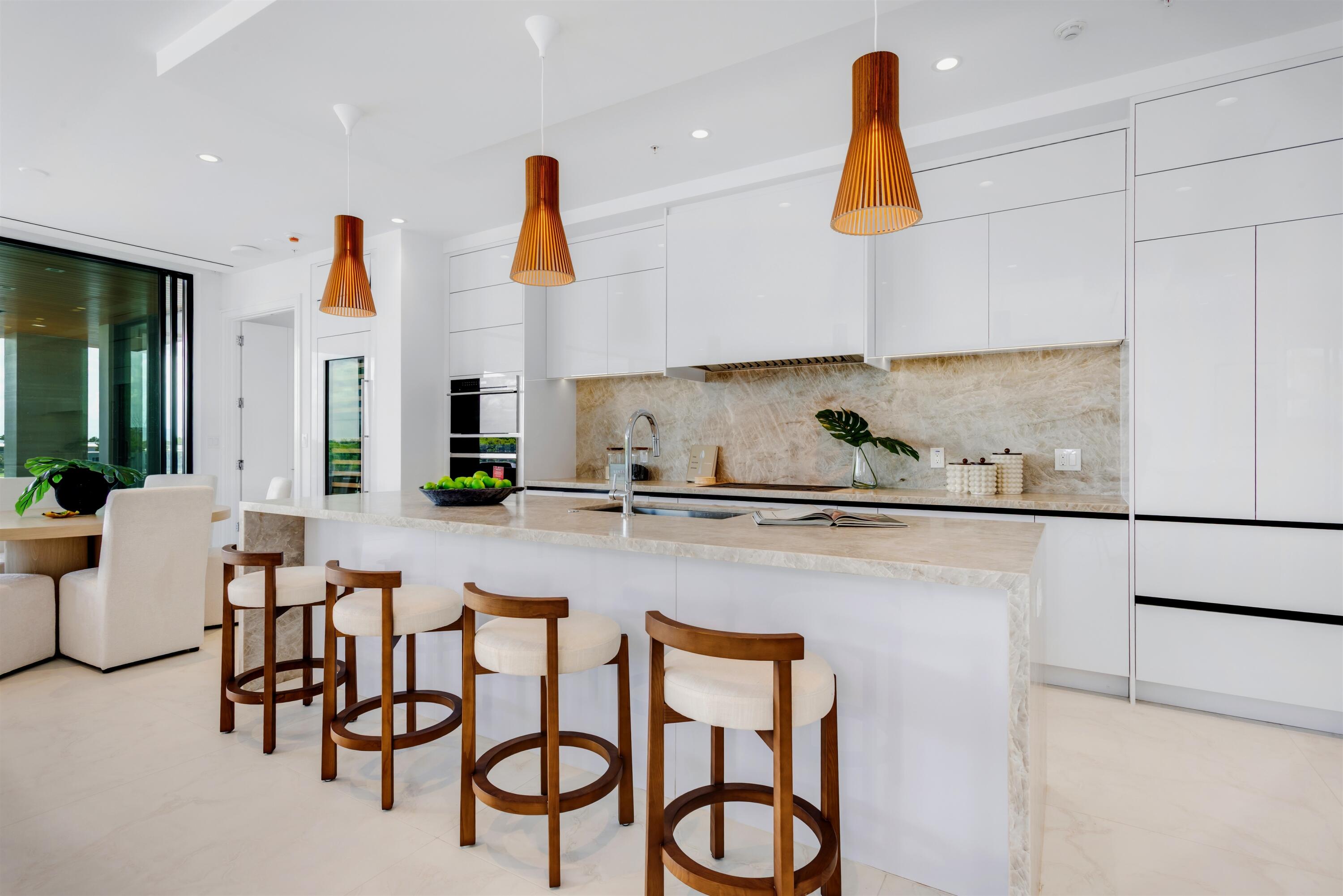 900 Lago Mar Lane, Unit PH Boca Raton, FL 33431 - Photo 12 of 58 a kitchen with stainless steel appliances granite countertop a sink and a white cabinets