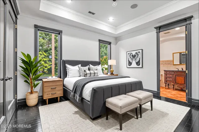 a bedroom with a bed and a painting on the wall