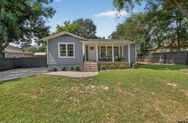 a front view of house with yard and green space