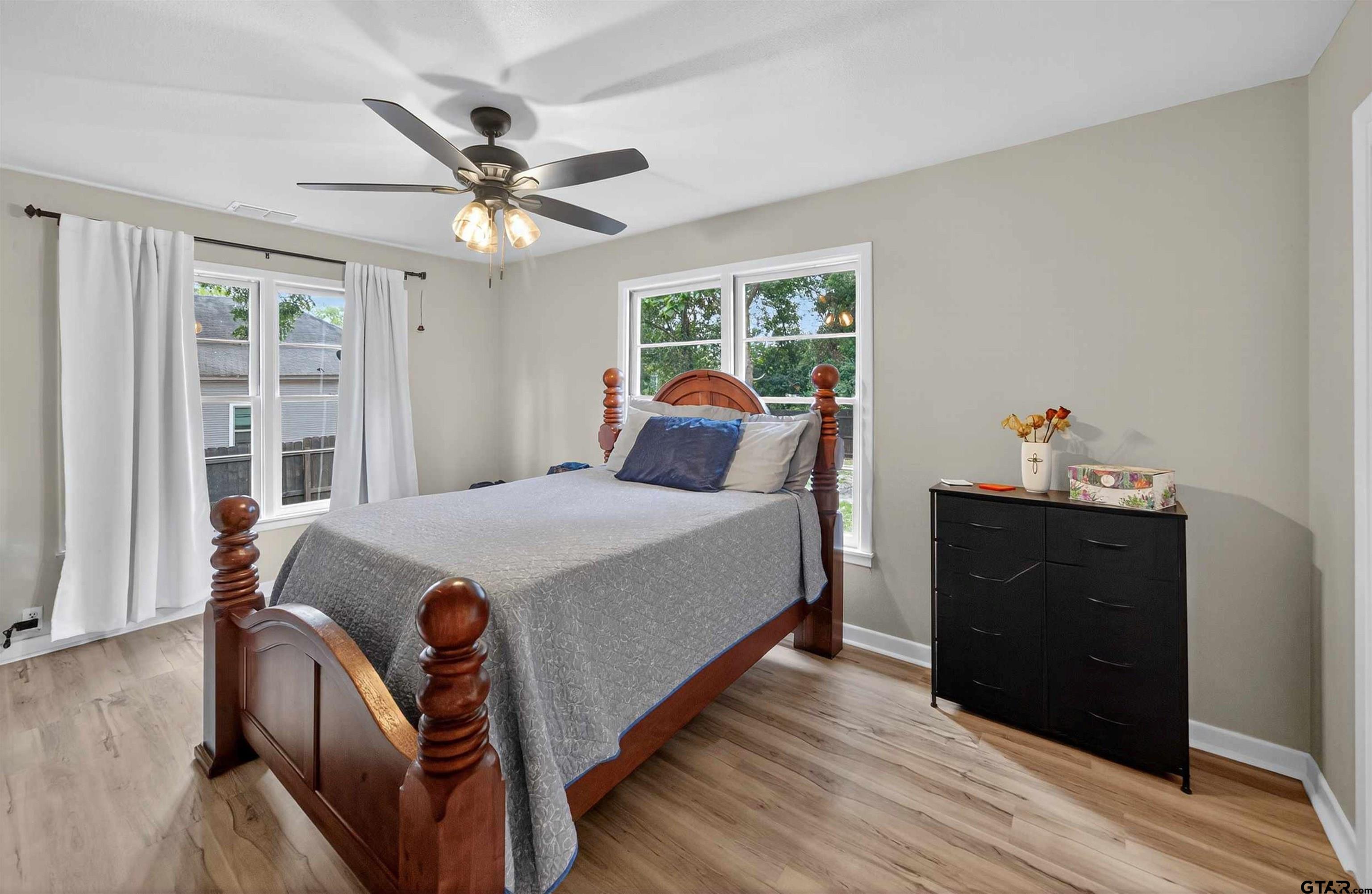 105 Holcomb Street Frankston, TX 75763 - Photo 9 of 13 a bedroom with a bed and wooden floor