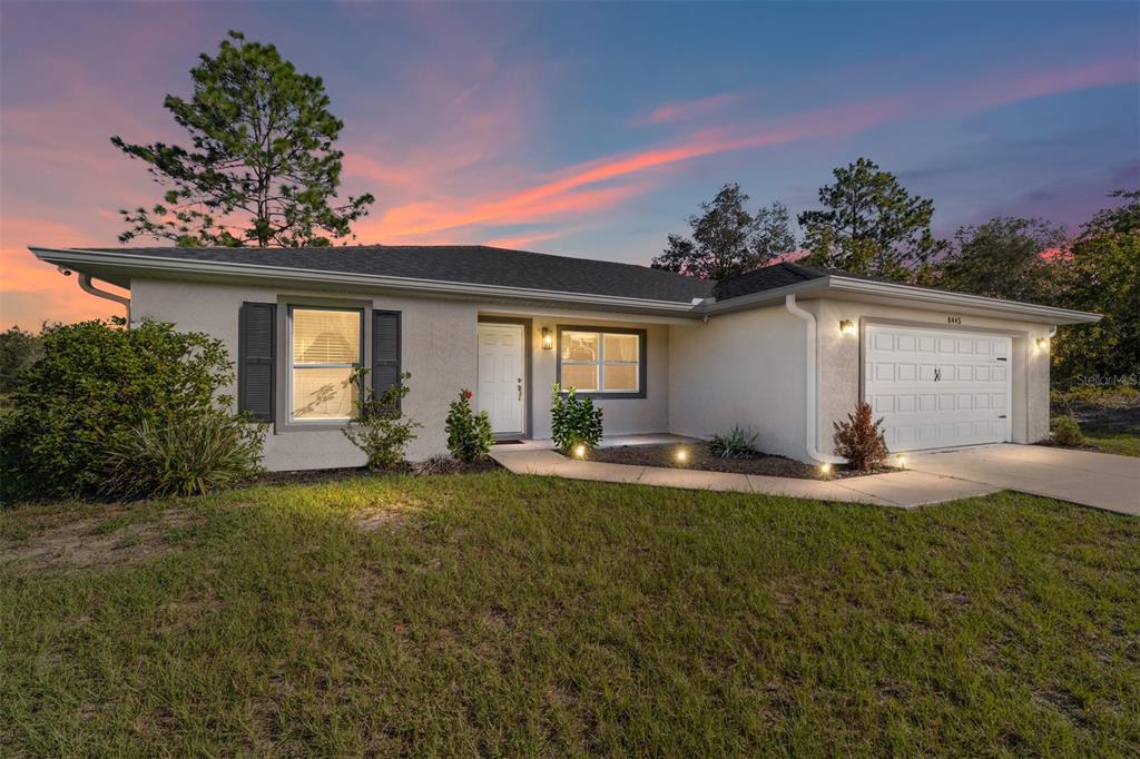 8445 Southwest 139th Lane Road Ocala, FL 34473 - Photo 1 of 1 a backyard of a house with table and chairs