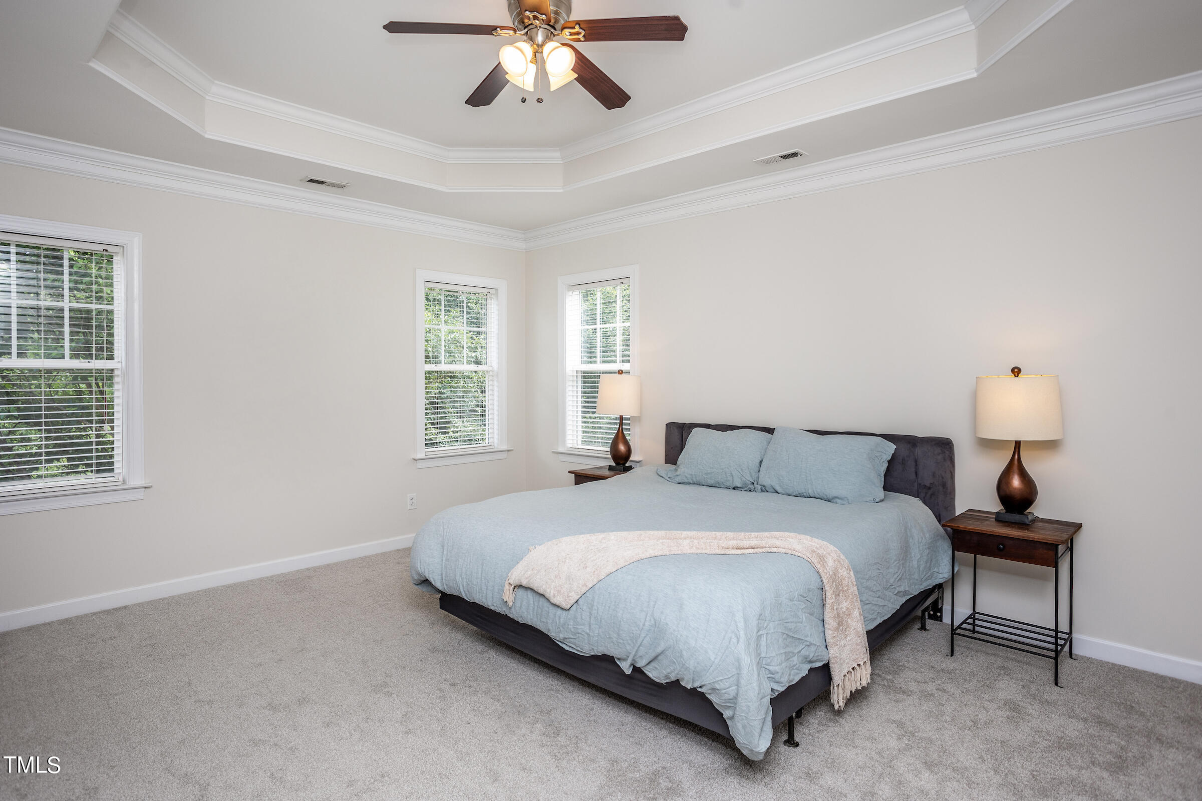 4709 All Points View Way Raleigh, NC 27614 - Photo 27 of 52 a bedroom with a bed lamp and a chandelier