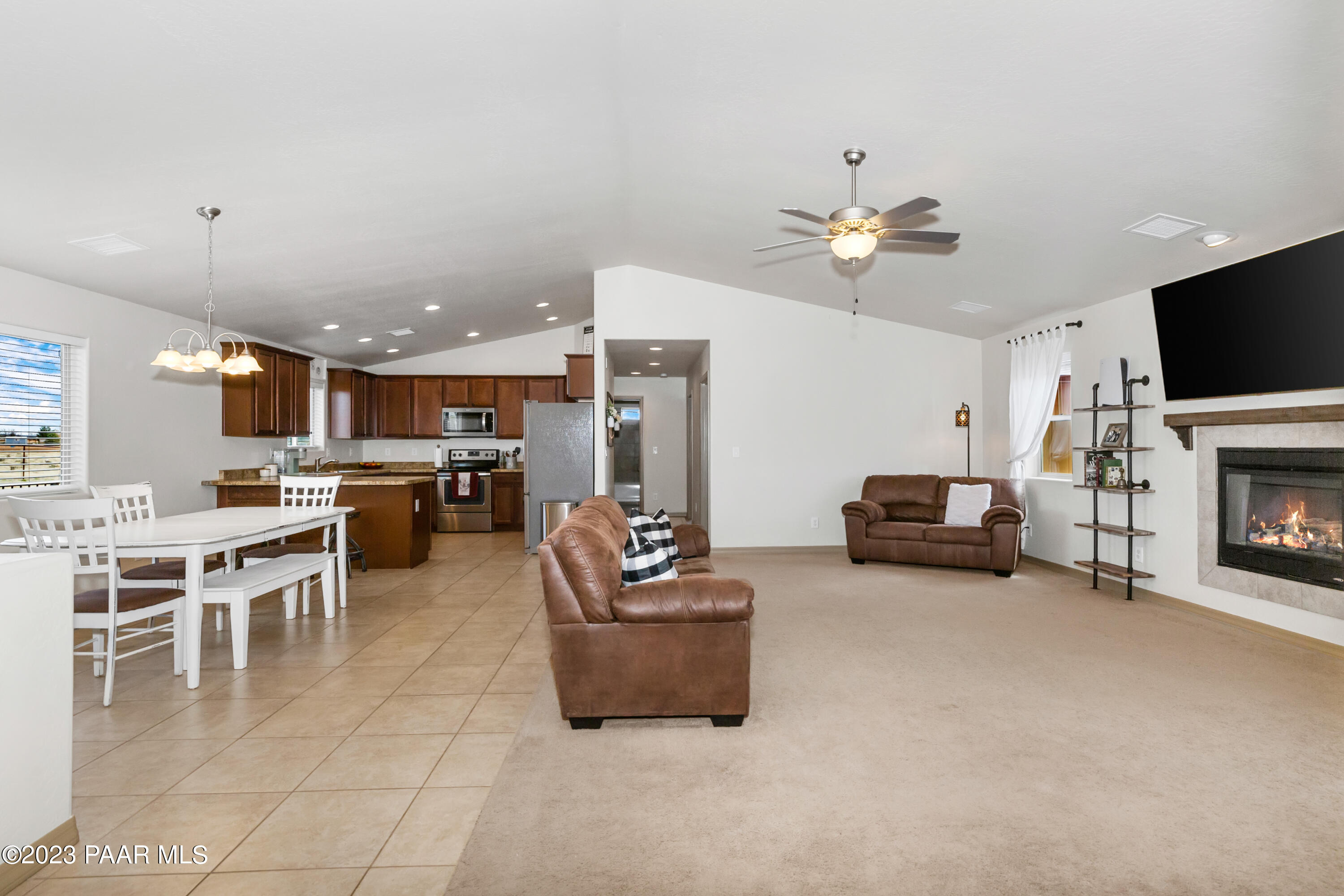 1475 Saddle Road Paulden, AZ 86334 - Photo 6 of 25 a living room with furniture a fireplace and a flat screen tv