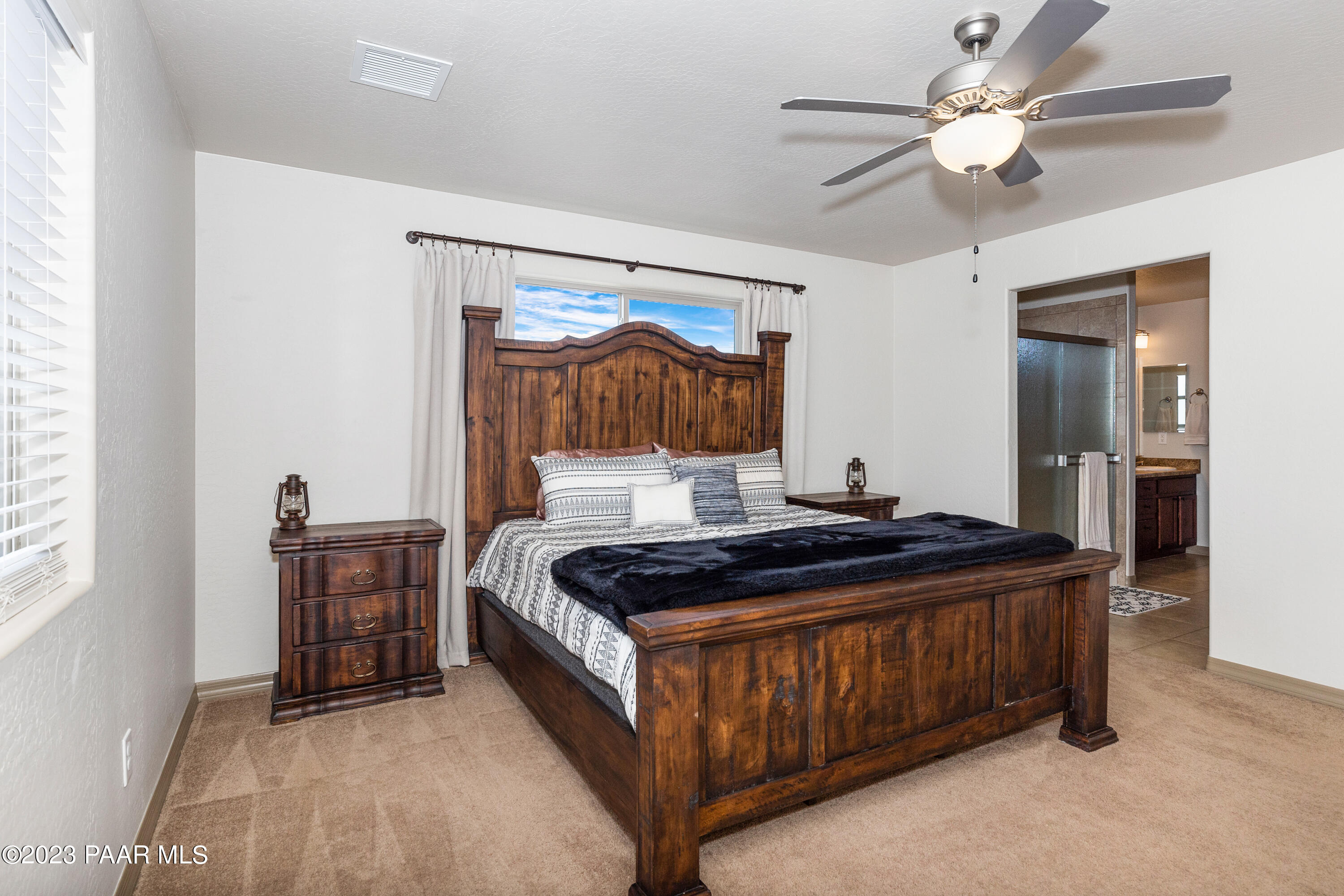 1475 Saddle Road Paulden, AZ 86334 - Photo 9 of 25 a bed room with a bed and a chandelier