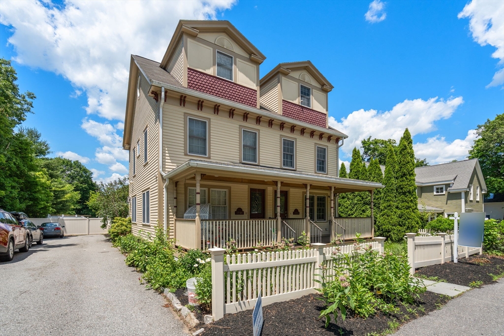 1844 Main Street, Unit 1 Concord, MA 01742 - Photo 31 of 36 a front view of a house with a garden