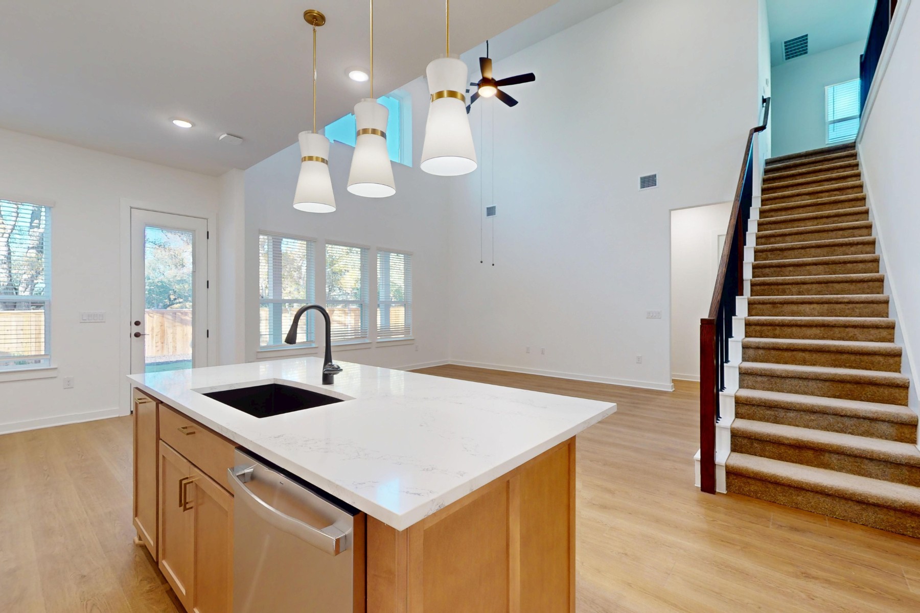 3613 Helena Way Leander, TX 78641 - Photo 12 of 27 a kitchen with a sink a chandelier stainless steel appliances and wooden floor