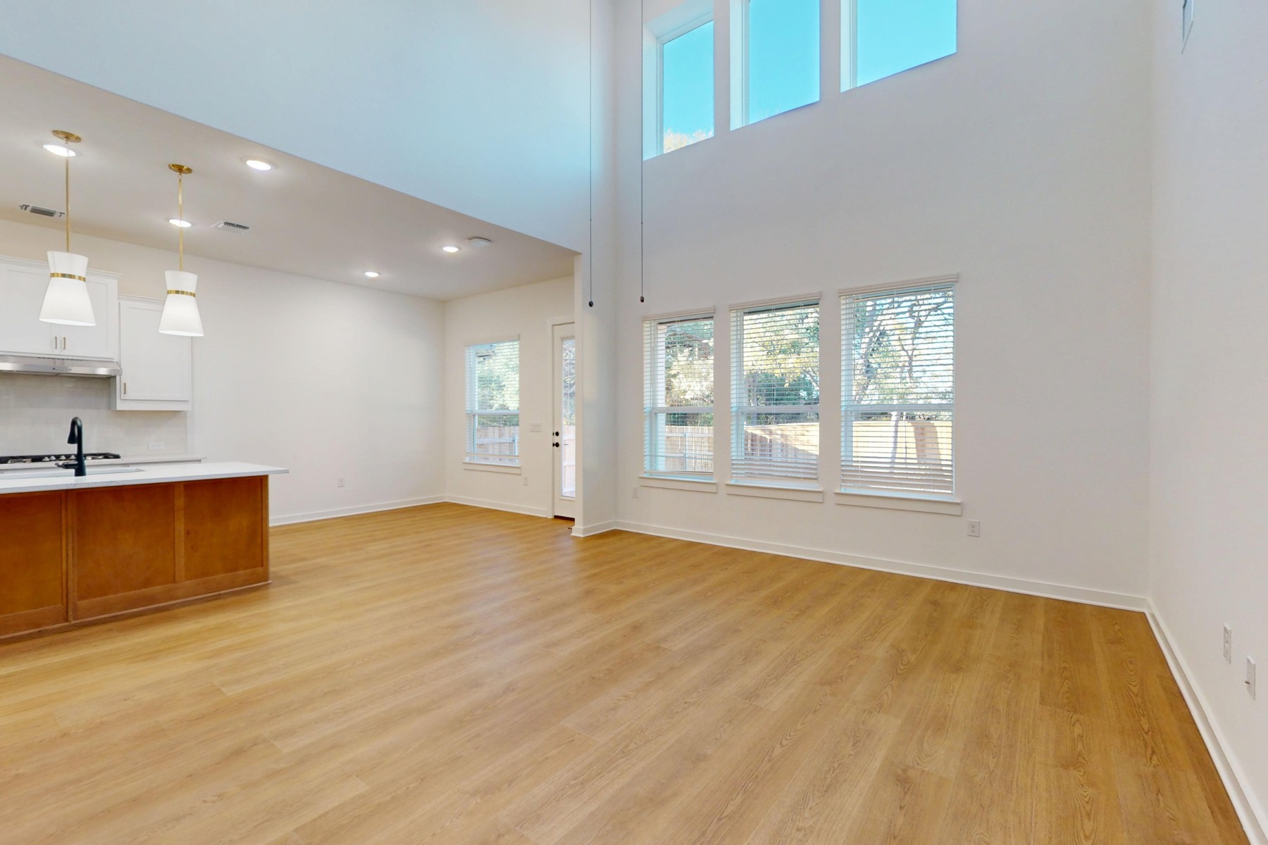 3613 Helena Way Leander, TX 78641 - Photo 15 of 27 a view of an empty room with a window and wooden floor