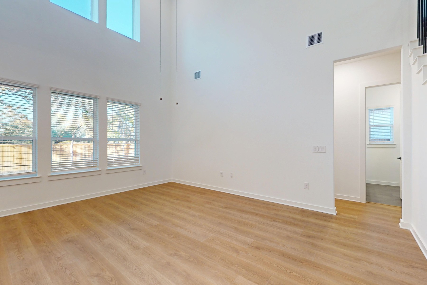 3613 Helena Way Leander, TX 78641 - Photo 16 of 27 a view of an empty room with wooden floor and a window