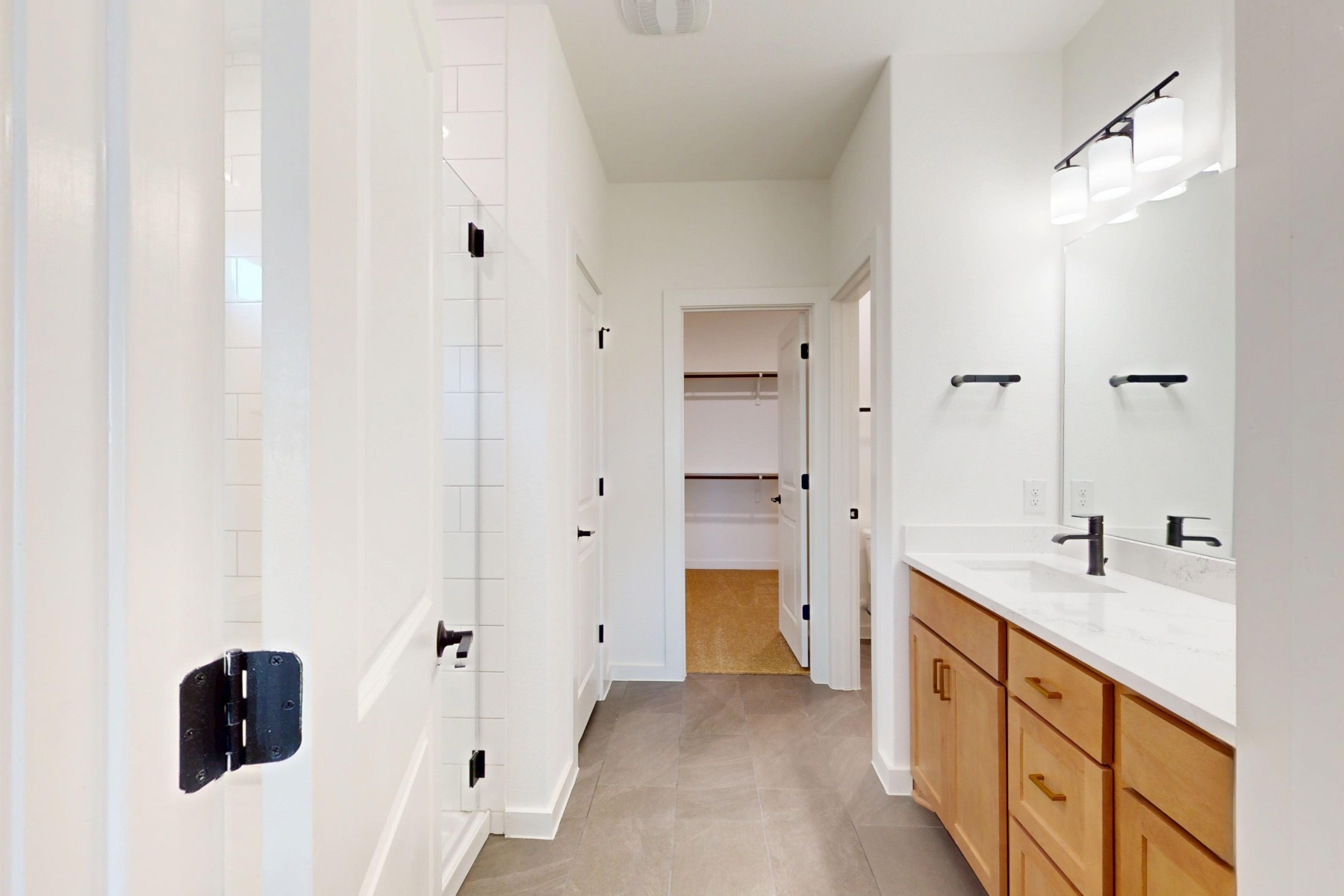 3613 Helena Way Leander, TX 78641 - Photo 20 of 27 a spacious bathroom with a double vanity sink a mirror and shower