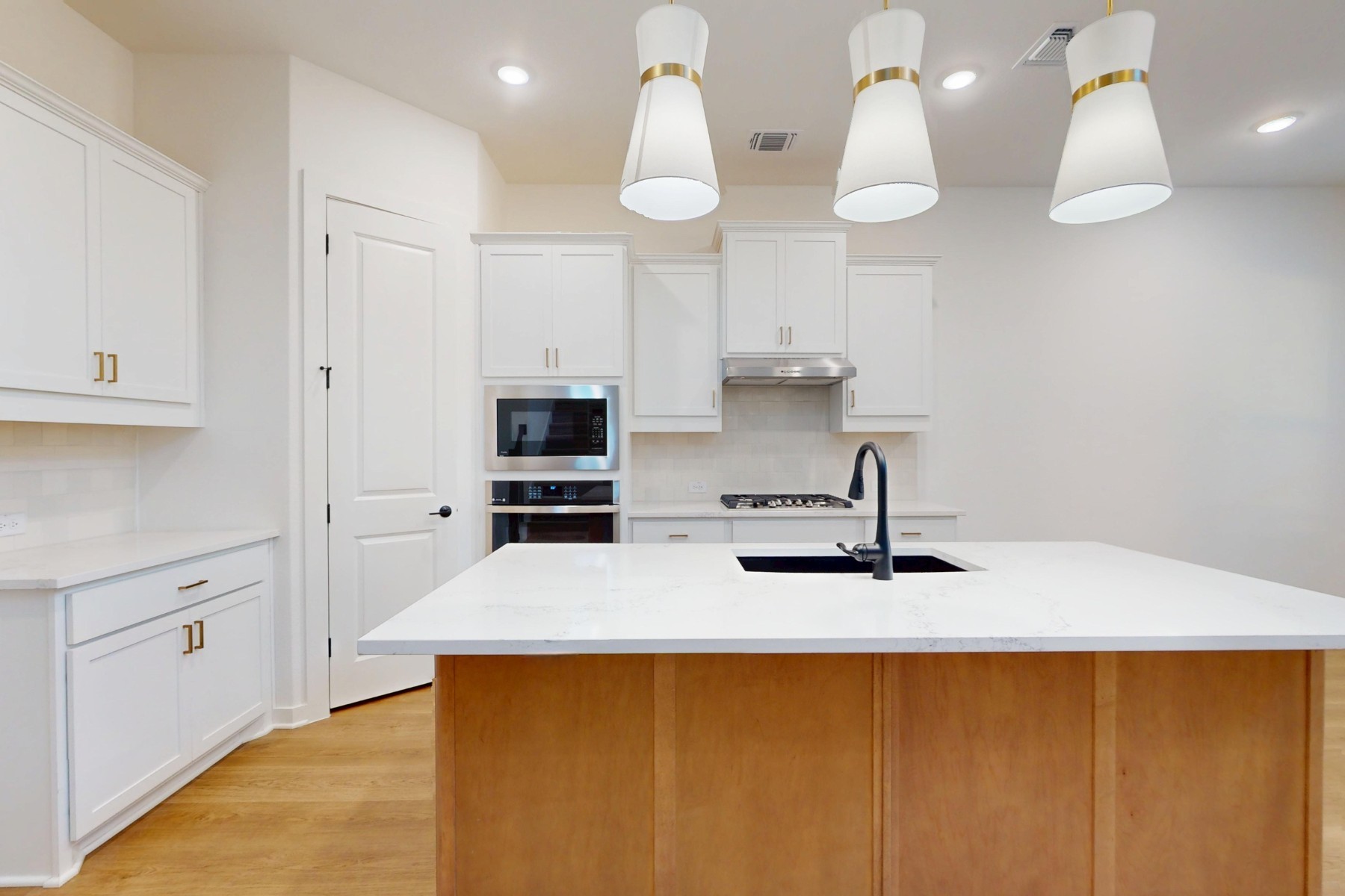 3613 Helena Way Leander, TX 78641 - Photo 7 of 27 a kitchen with stainless steel appliances a counter space a sink and cabinets