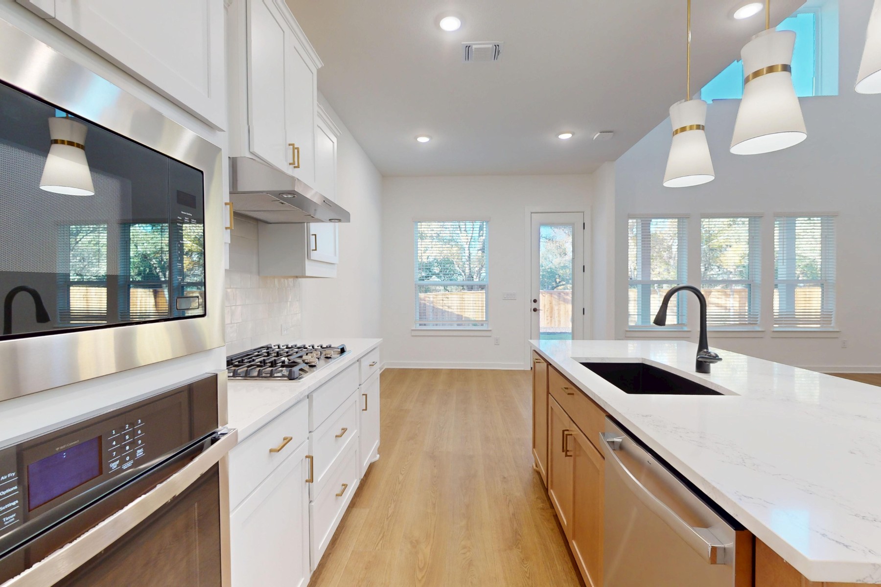 3613 Helena Way Leander, TX 78641 - Photo 9 of 27 a kitchen with granite countertop a stove and a sink