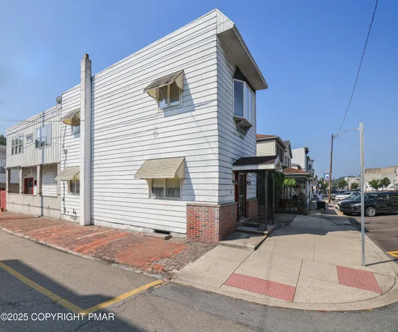 a view of a brick house with large windows