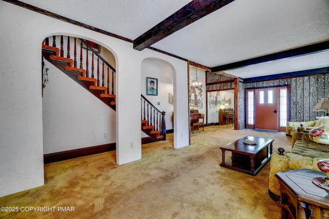 a open kitchen with stainless steel appliances granite countertop a stove a refrigerator and a wooden cabinets