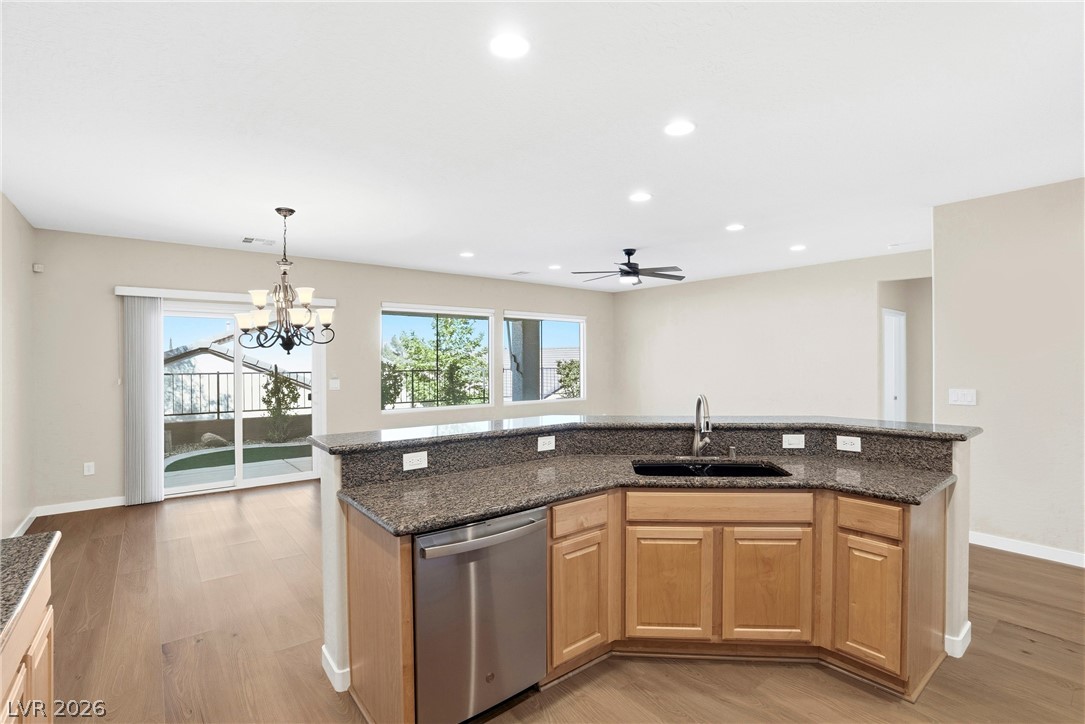 2541 Darda Street Henderson, NV 89044 - Photo 2 of 26 This spacious kitchen and dining area features rich countertops, modern appliances, and seamless outdoor access.
