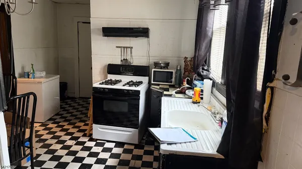 a kitchen with a stove a sink and a refrigerator