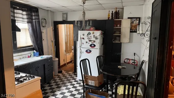 a kitchen with stainless steel appliances a refrigerator a sink a stove and a refrigerator