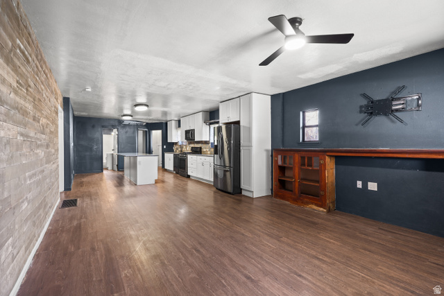 2576 Gramercy Avenue Ogden, UT 84401 - Photo 20 of 20 Kitchen featuring white cabinetry, stainless steel appliances, dark wood-style flooring, a kitchen island, and open floor plan