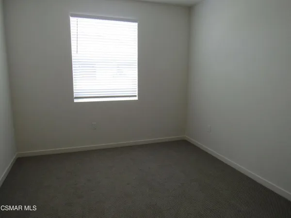 a view of a bathroom with two sinks and a window
