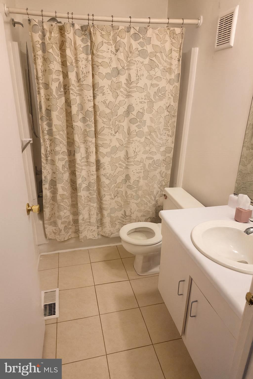 407 Harrier Row Marlton, NJ 08053 - Photo 9 of 13 a bathroom with a toilet and a shower curtain