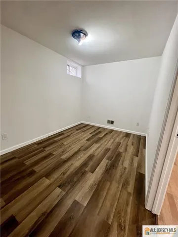 a view of room with wooden floor