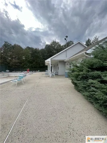 a view of a house with roof and a tree