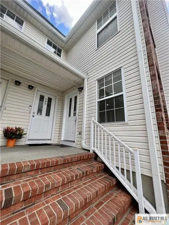 a front view of a house with stairs