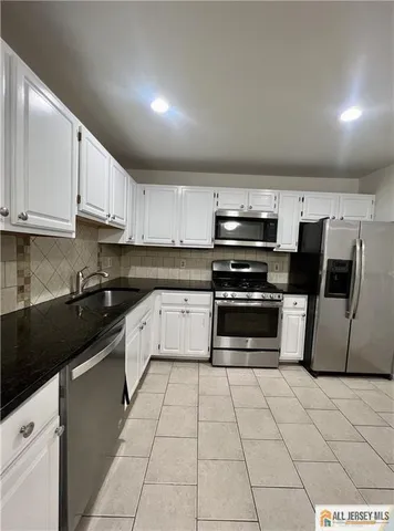 a kitchen with stainless steel appliances and cabinets