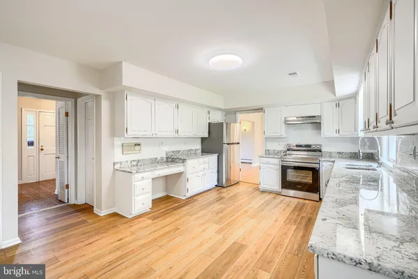 a bathroom with a sink a toilet and a window