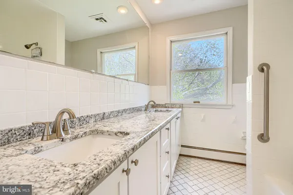 a bathroom with a sink a toilet and mirror