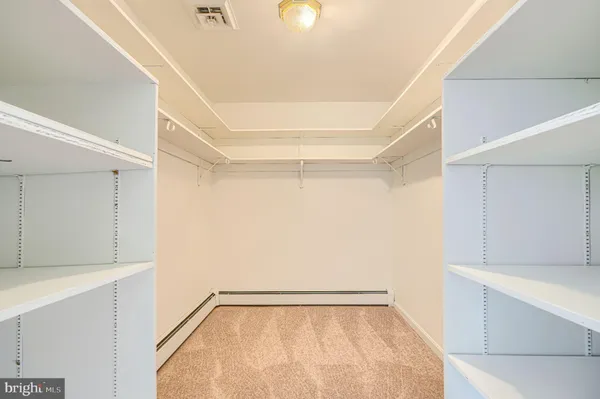 a picture of a room with a white wall and a refrigerator
