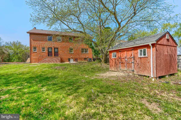a view of empty room with wooden floor and fireplace