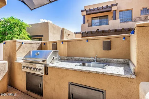a view of patio with a table and chairs under an umbrella