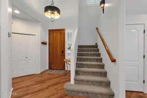 a view of an entryway with wooden floor