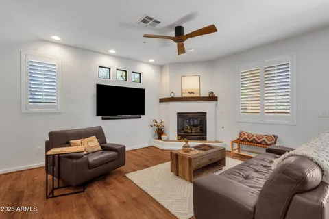 a living room with furniture a flat screen tv and a fireplace