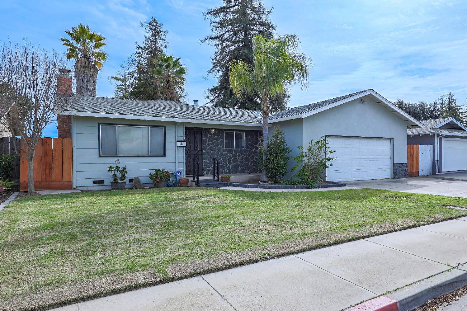 a front view of house with yard and trees