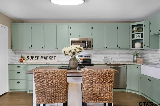 a kitchen with cabinets a sink and a stove