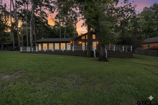 a backyard of a house with lots of green space and garden