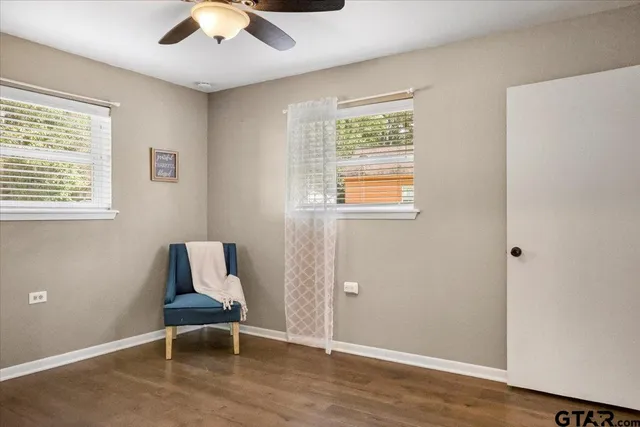 a living room with a window and wooden floor