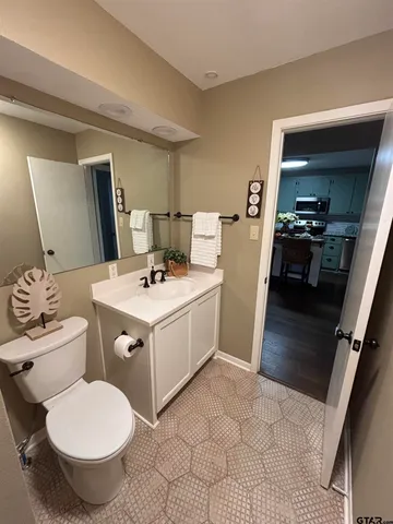 a bathroom with a toilet sink and mirror