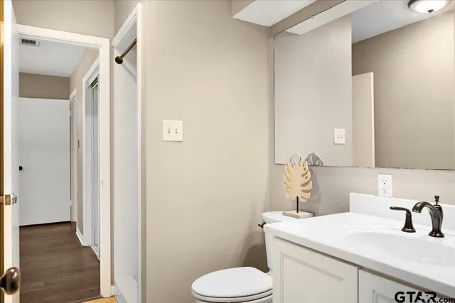 a bathroom with a toilet sink and a mirror