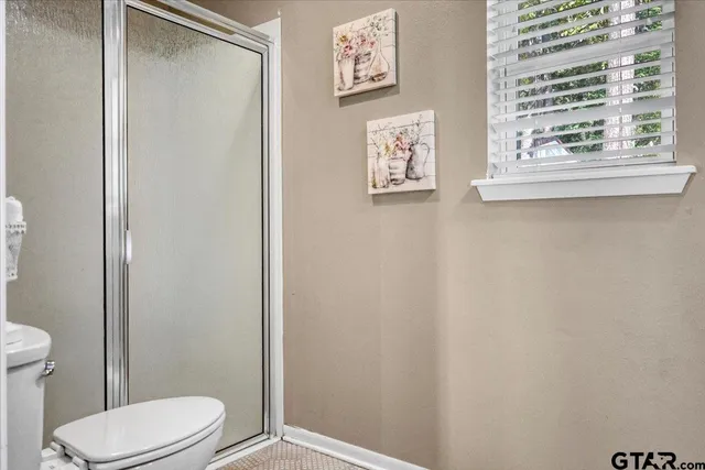 a white toilet sitting next to a bathroom sink