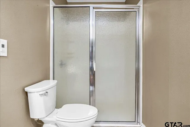 a white toilet sitting next to a bathroom sink