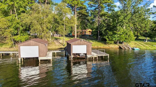 a view of a lake with table and chairs