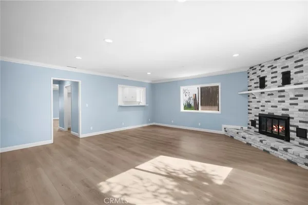 a view of a livingroom with a fireplace and window