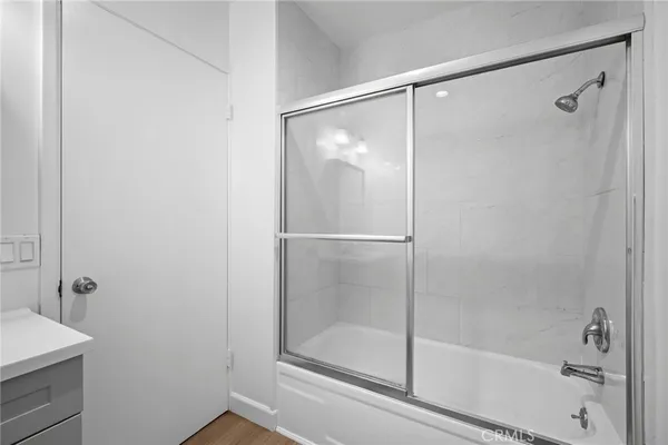 a bathroom with a glass shower door