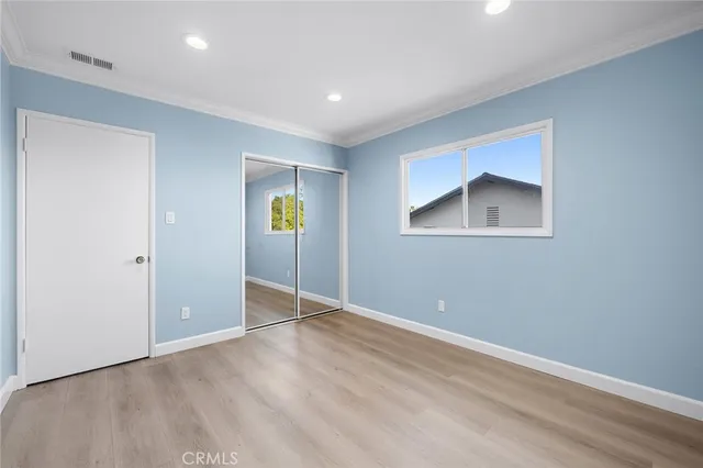 an empty room with windows and closet